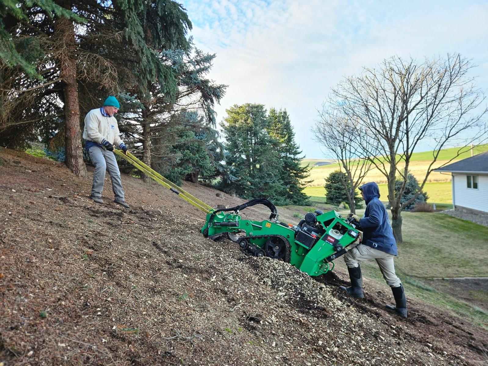 Crew grinding a stump on a Palouse hillside